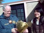 Jackson Police Chief Scott Morrison receives a gift for Chinese New Year from Hong Wang and the ERDT group.